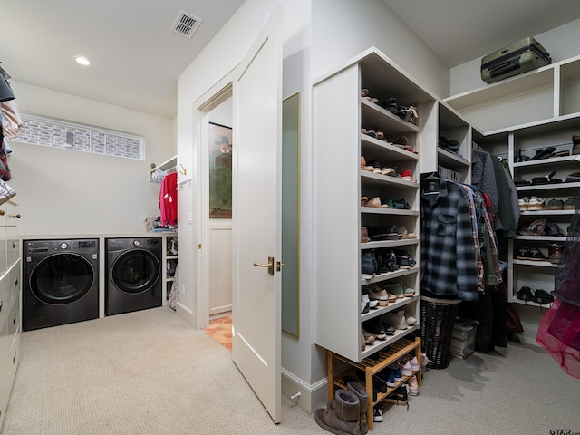 spacious closet with carpet floors, independent washer and dryer, and visible vents