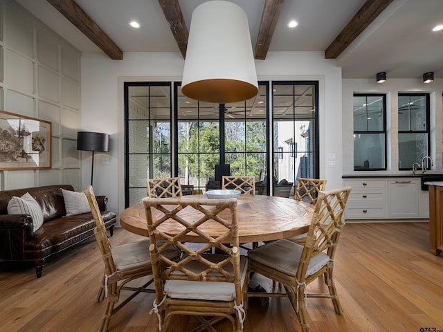 dining space featuring recessed lighting, beam ceiling, and light wood-style floors