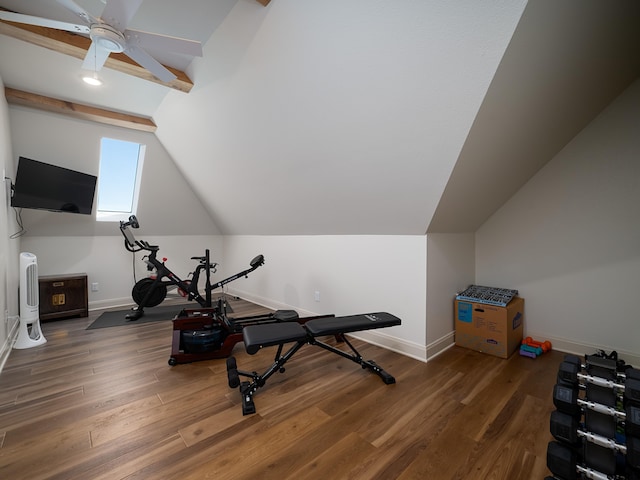 workout area featuring ceiling fan, baseboards, vaulted ceiling, and wood finished floors