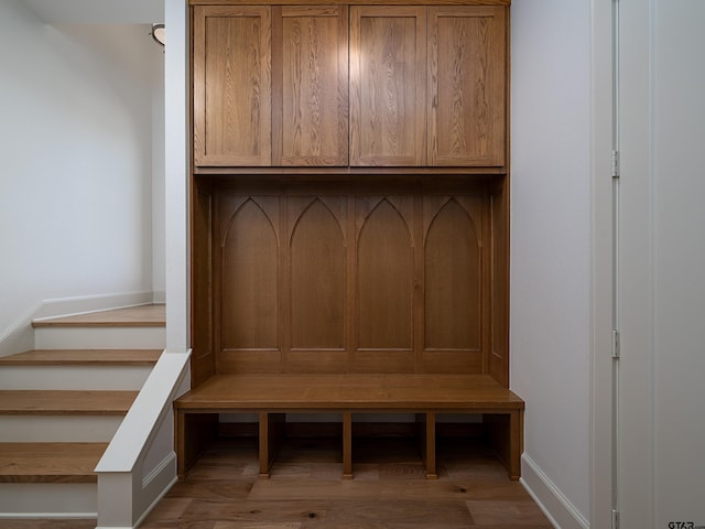 mudroom featuring baseboards and wood finished floors