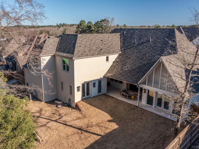 back of house featuring french doors, roof with shingles, a patio, and fence