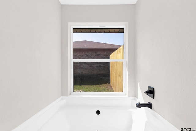 bathroom featuring a bathtub and a wealth of natural light