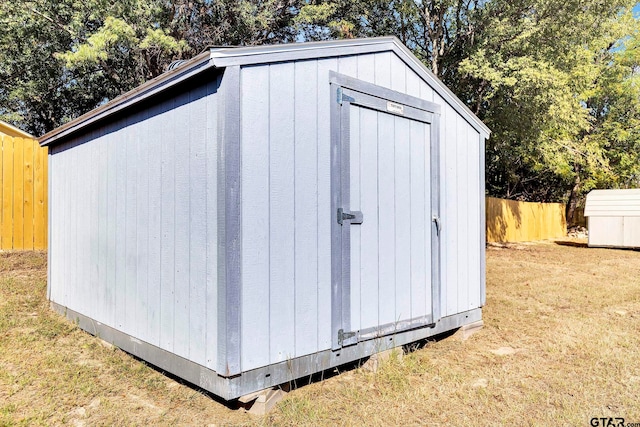 view of shed with fence