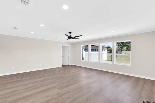 interior space featuring recessed lighting, baseboards, visible vents, a ceiling fan, and wood finished floors