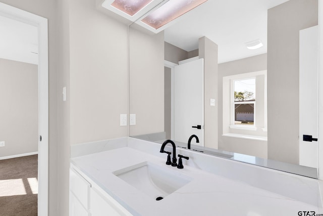 bathroom with baseboards and vanity