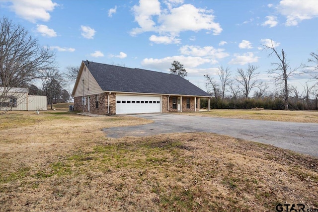 view of front of house featuring a garage and a front lawn