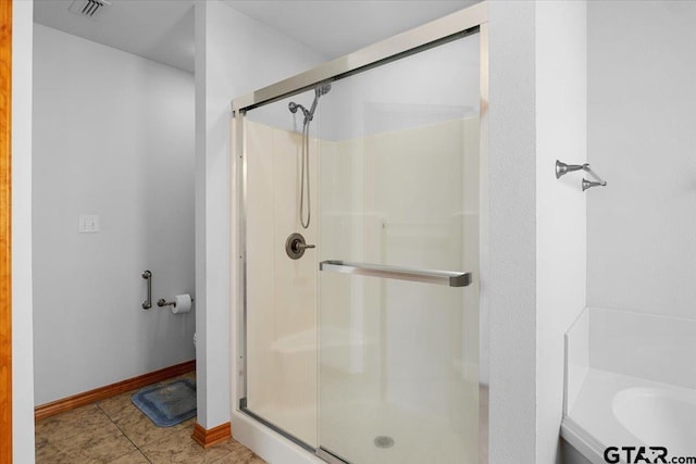 bathroom featuring independent shower and bath and tile patterned flooring