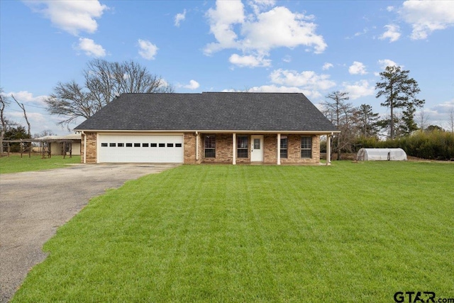 view of front of property with a garage and a front yard