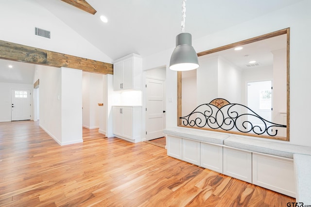 hallway with lofted ceiling with beams and light hardwood / wood-style flooring