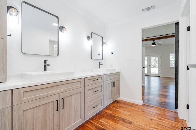 bathroom with vanity, hardwood / wood-style flooring, ceiling fan, and crown molding