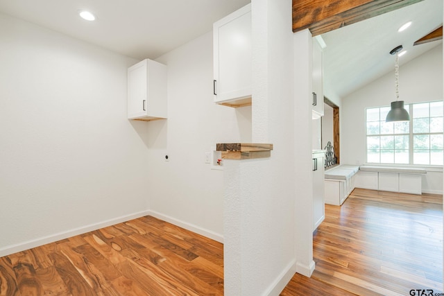 laundry room with hookup for an electric dryer, light wood-type flooring, and washer hookup