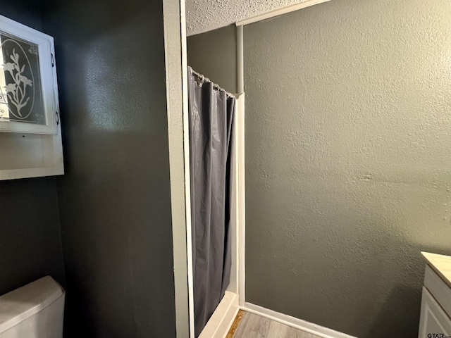1725 S Mahon Ave, Tyler, TX 75701 - full bath featuring vanity, wood finished floors, and a shower with shower curtain