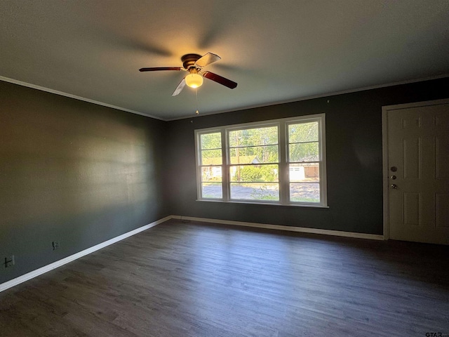 1725 S Mahon Ave, Tyler, TX 75701 - empty room featuring a ceiling fan, dark wood-style flooring, and ornamental molding