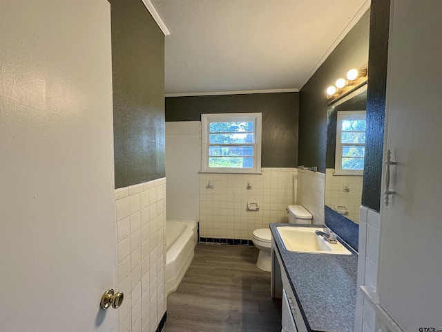 1725 S Mahon Ave, Tyler, TX 75701 - full bathroom with tile walls, a bathtub, crown molding, wood finished floors, and vanity