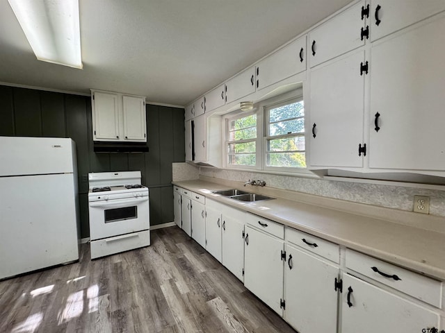 1725 S Mahon Ave, Tyler, TX 75701 - kitchen with white appliances, under cabinet range hood, white cabinetry, wood finished floors, and light countertops