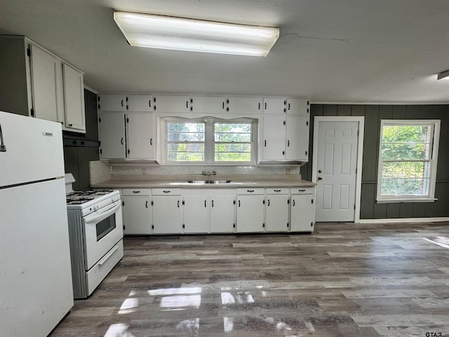 1725 S Mahon Ave, Tyler, TX 75701 - kitchen with white appliances, white cabinets, light countertops, and under cabinet range hood