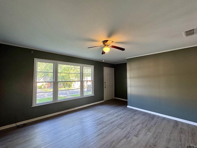 1725 S Mahon Ave, Tyler, TX 75701 - empty room with wood finished floors, a ceiling fan, and ornamental molding