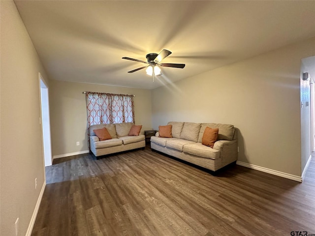 living room featuring ceiling fan and dark hardwood / wood-style floors