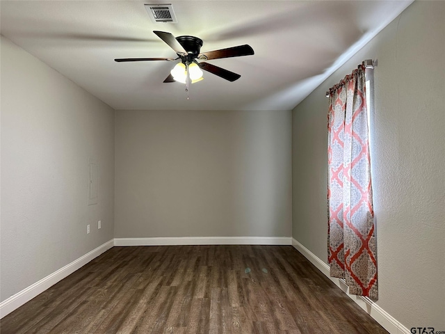 unfurnished room with ceiling fan and dark hardwood / wood-style flooring