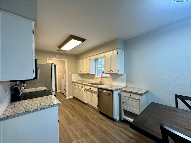 kitchen featuring decorative backsplash, appliances with stainless steel finishes, and white cabinetry