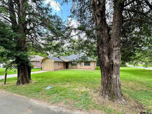 ranch-style house featuring a garage and a front lawn