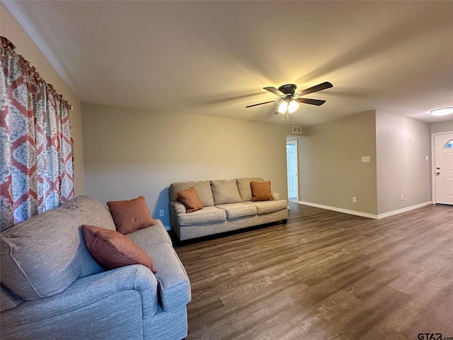 living room with dark hardwood / wood-style floors and ceiling fan