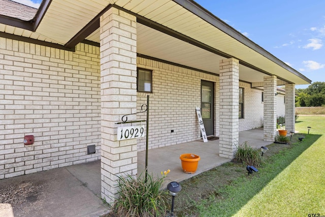10929 County Road 41, Tyler, TX 75706 - property entrance featuring covered porch, a yard, and brick siding