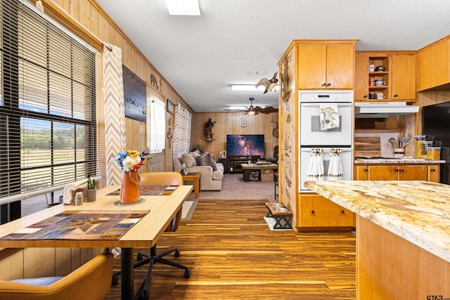 10929 County Road 41, Tyler, TX 75706 - dining area featuring wood walls, wood finished floors, and a textured ceiling
