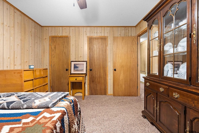 10929 County Road 41, Tyler, TX 75706 - carpeted bedroom featuring ornamental molding, wooden walls, and a textured ceiling