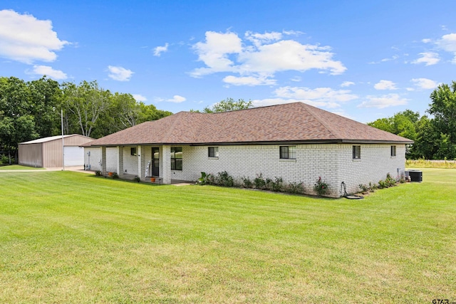 10929 County Road 41, Tyler, TX 75706 - back of property featuring a garage, a yard, brick siding, and an outdoor structure