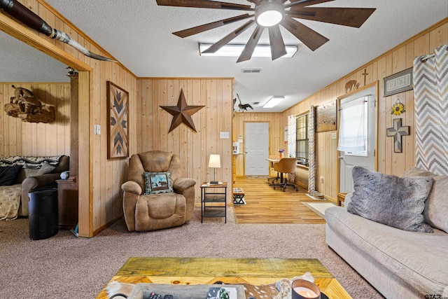 10929 County Road 41, Tyler, TX 75706 - living room with wooden walls, ceiling fan, carpet flooring, and a textured ceiling