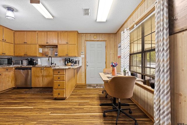 10929 County Road 41, Tyler, TX 75706 - kitchen with stainless steel appliances, dark wood-type flooring, an office area, wood walls, and light countertops