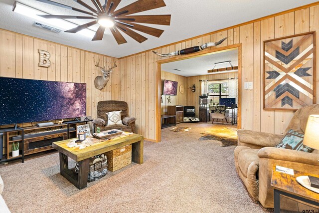 10929 County Road 41, Tyler, TX 75706 - living area featuring wooden walls, crown molding, carpet floors, and a textured ceiling