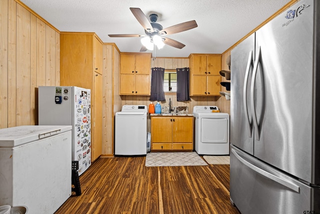 10929 County Road 41, Tyler, TX 75706 - kitchen with freestanding refrigerator, washer / dryer, a ceiling fan, wood walls, and dark wood-style flooring