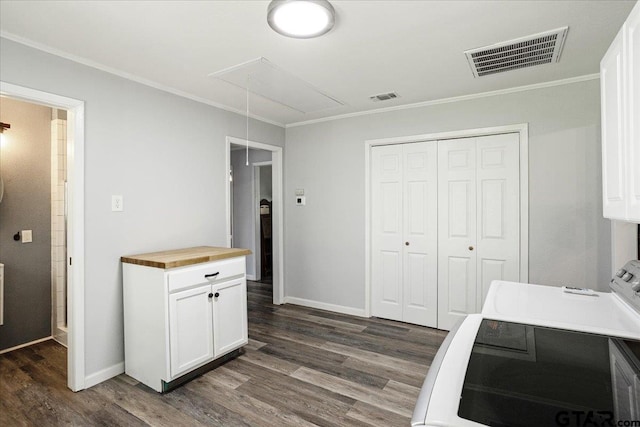 3268 Farm Rd Unit 1487, Bogata, TX 75417 - kitchen with dark wood-style flooring, wood counters, white cabinetry, crown molding, and washer / dryer
