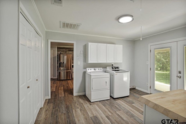 3268 Farm Rd Unit 1487, Bogata, TX 75417 - laundry area featuring separate washer and dryer, cabinet space, crown molding, and wood finished floors