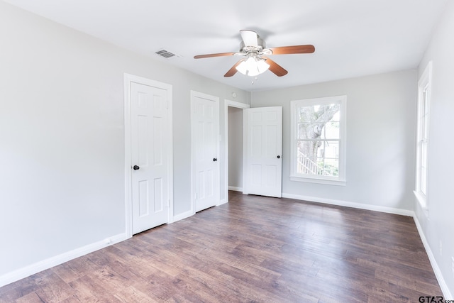 620 Dulse St, Tyler, TX 75701 - unfurnished bedroom featuring dark wood-style floors and a ceiling fan