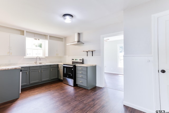 620 Dulse St, Tyler, TX 75701 - kitchen featuring stainless steel range with electric cooktop, wall chimney exhaust hood, gray cabinetry, open shelves, and healthy amount of natural light