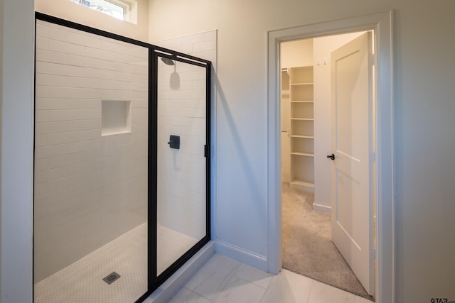 bathroom featuring a shower with shower door