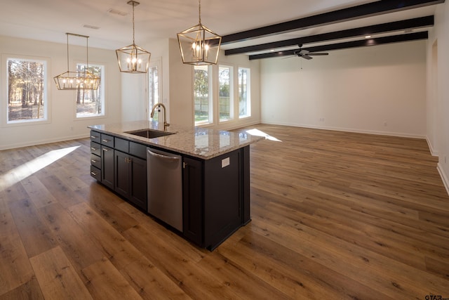 kitchen featuring ceiling fan, a kitchen island with sink, sink, dishwasher, and beamed ceiling