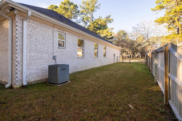 view of home's exterior with a lawn and central air condition unit