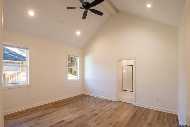 empty room with beamed ceiling, light wood-type flooring, high vaulted ceiling, and ceiling fan