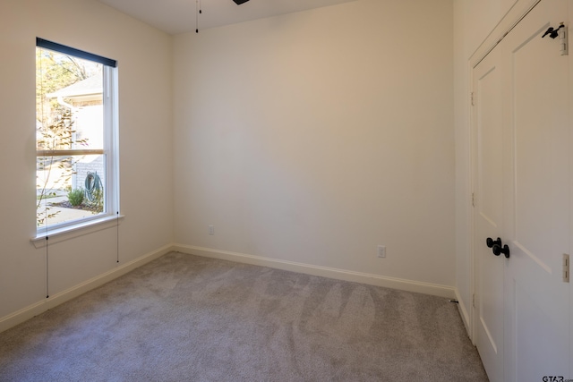 unfurnished room featuring light carpet and ceiling fan