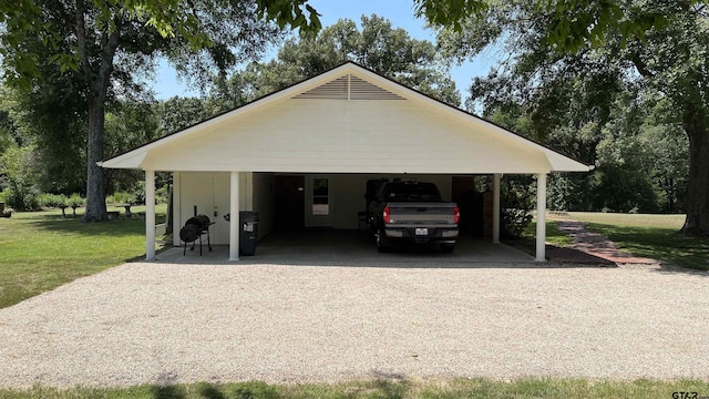 garage with a yard and a carport