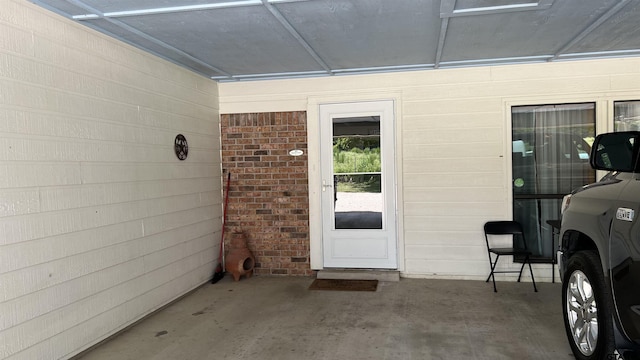 view of exterior entry with a patio area