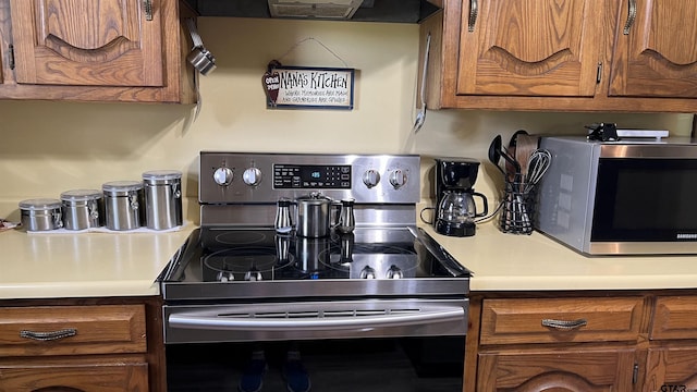 kitchen with range hood and appliances with stainless steel finishes