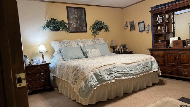 bedroom with crown molding and light colored carpet