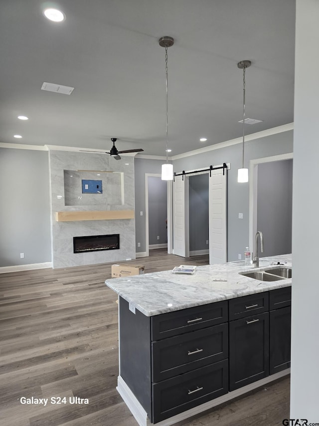 913 Alex Dr, Whitehouse, TX 75791 - kitchen featuring crown molding, dark cabinetry, a ceiling fan, a fireplace, and recessed lighting