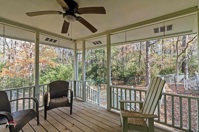 sunroom / solarium featuring ceiling fan