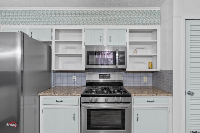 kitchen featuring crown molding, stainless steel appliances, dark stone counters, and backsplash